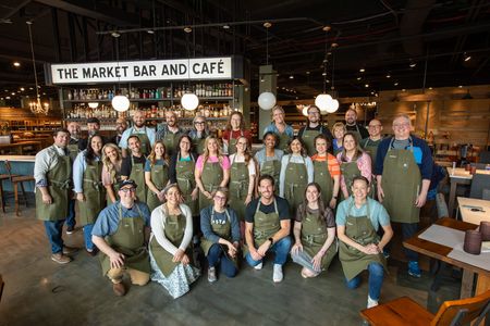 Our group in custom aprons after making pizzas. Photo by Marisa Uluski at 5 Tool Productions