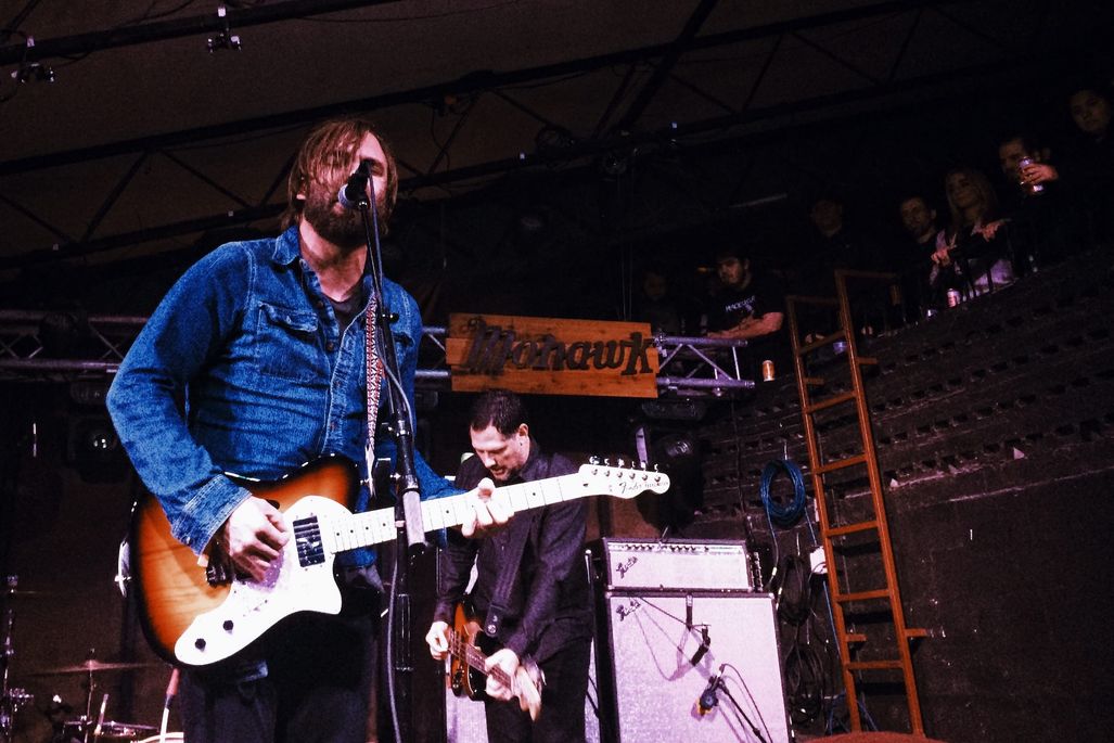 Chris Simpson of the band Mineral holding his telecaster and singing into the mic at The Mohawk.
