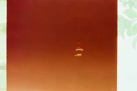 An abstract image with the faint glow of a lightbulb emerging through the murk.